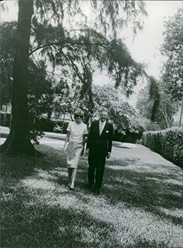 Гроздобер фотографија на Хенри Кабот Лоџ, rуниор Одење со жена, во градина.